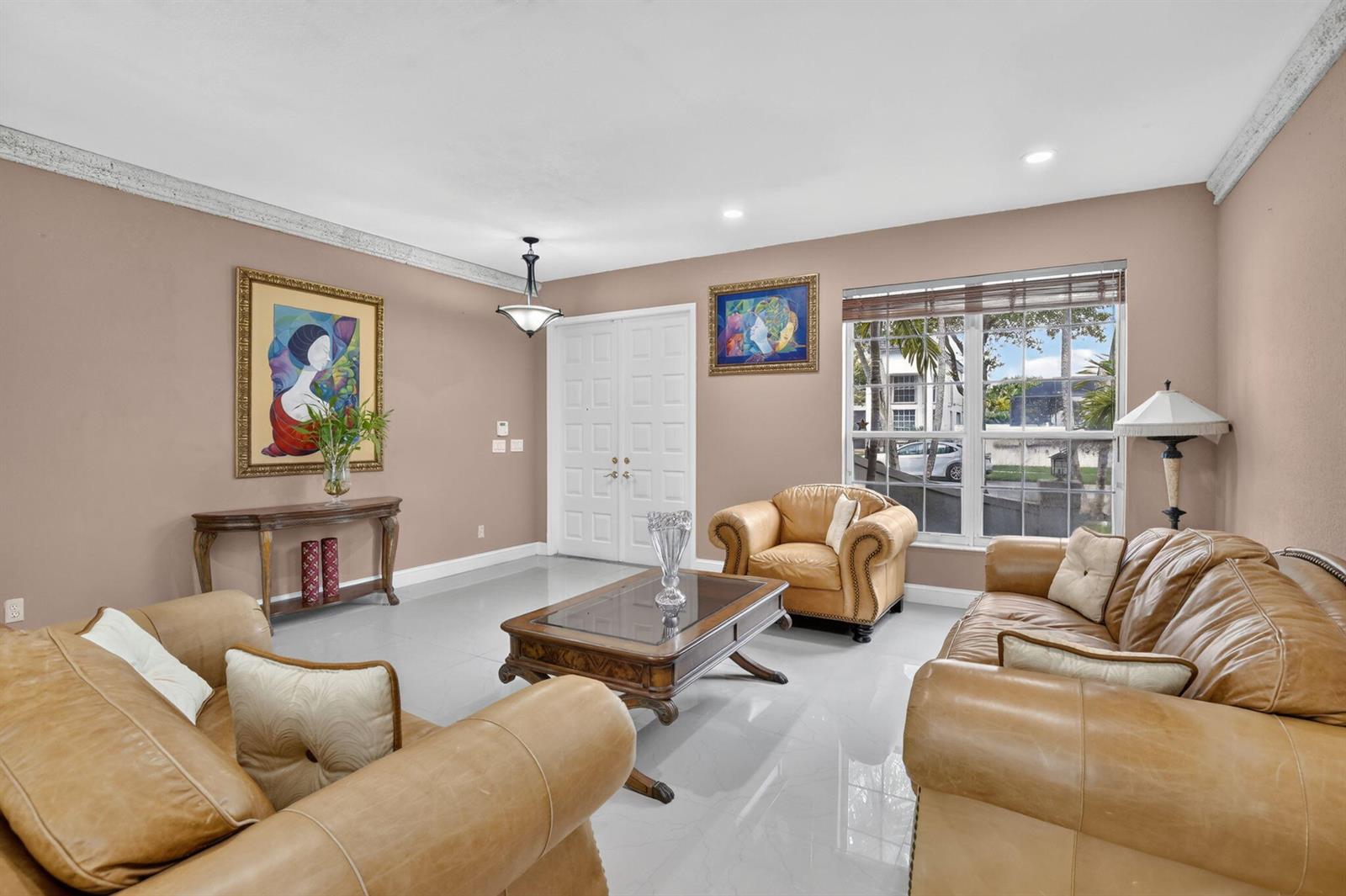 A living room features tan leather furniture, a glass-top coffee table, and light tile flooring — 3535 SW 177th Avenue, Miramar FL 33029, MIRAMAR, FL