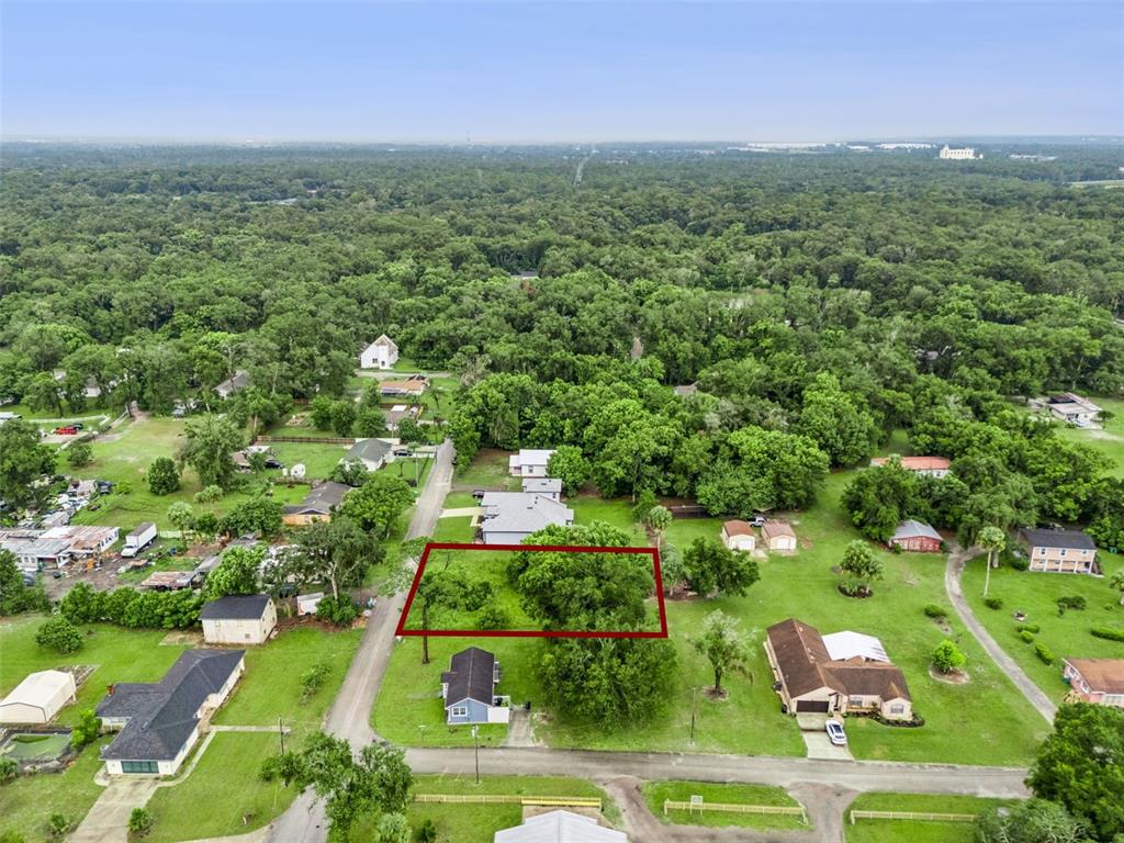An aerial view shows a rectangular vacant lot outlined in red within a residential neighborhood — S GOODWIN STREET, LAKE HELEN, FL
