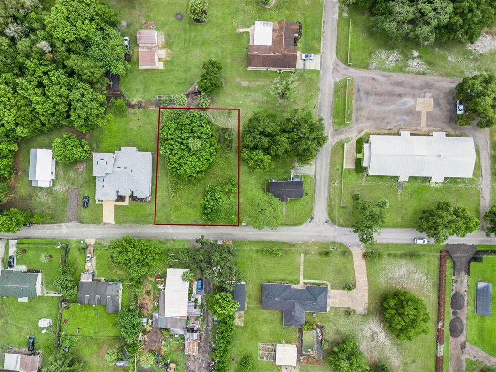 An aerial view shows a vacant, rectangular lot outlined in red within a residential neighborhood — S GOODWIN STREET, LAKE HELEN, FL