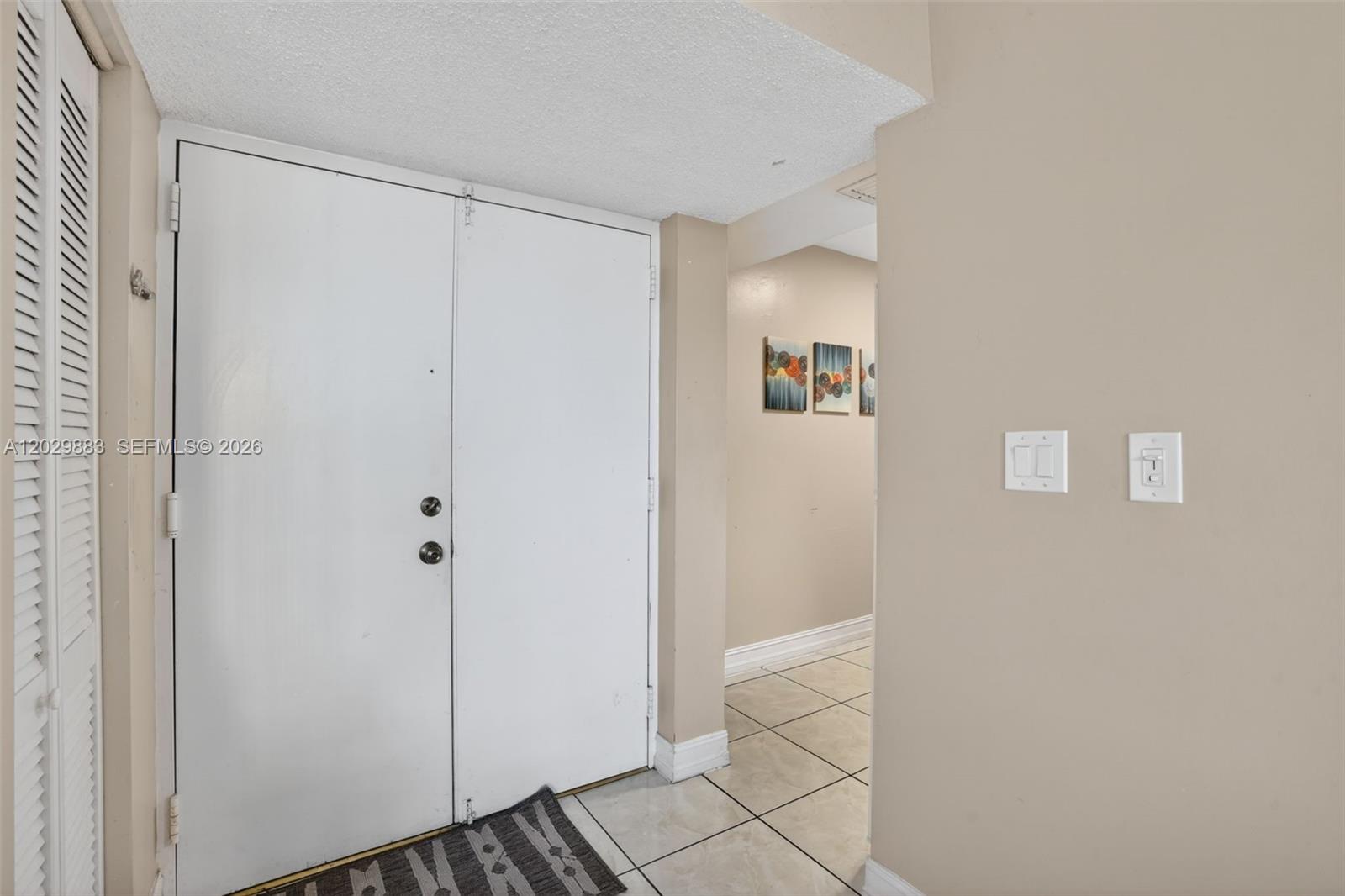 A white double door entry leads into a tiled hallway with light-colored walls — 11790 SW 18th St # 3, Miami FL 33175, MIAMI, FL
