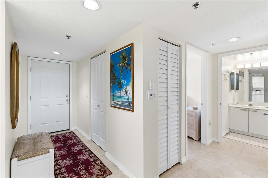 An entryway with a white door, a patterned rug, and a view into a bathroom — 3950 IRONWOOD CIRCLE UNIT 205, BRADENTON, FL
