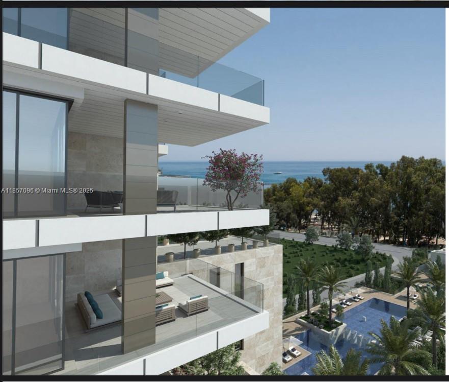 This architectural rendering shows modern balconies with glass railings overlooking a pool and the ocean — Limassol 12 ARCH Makariou # 12, FL 33180, FL