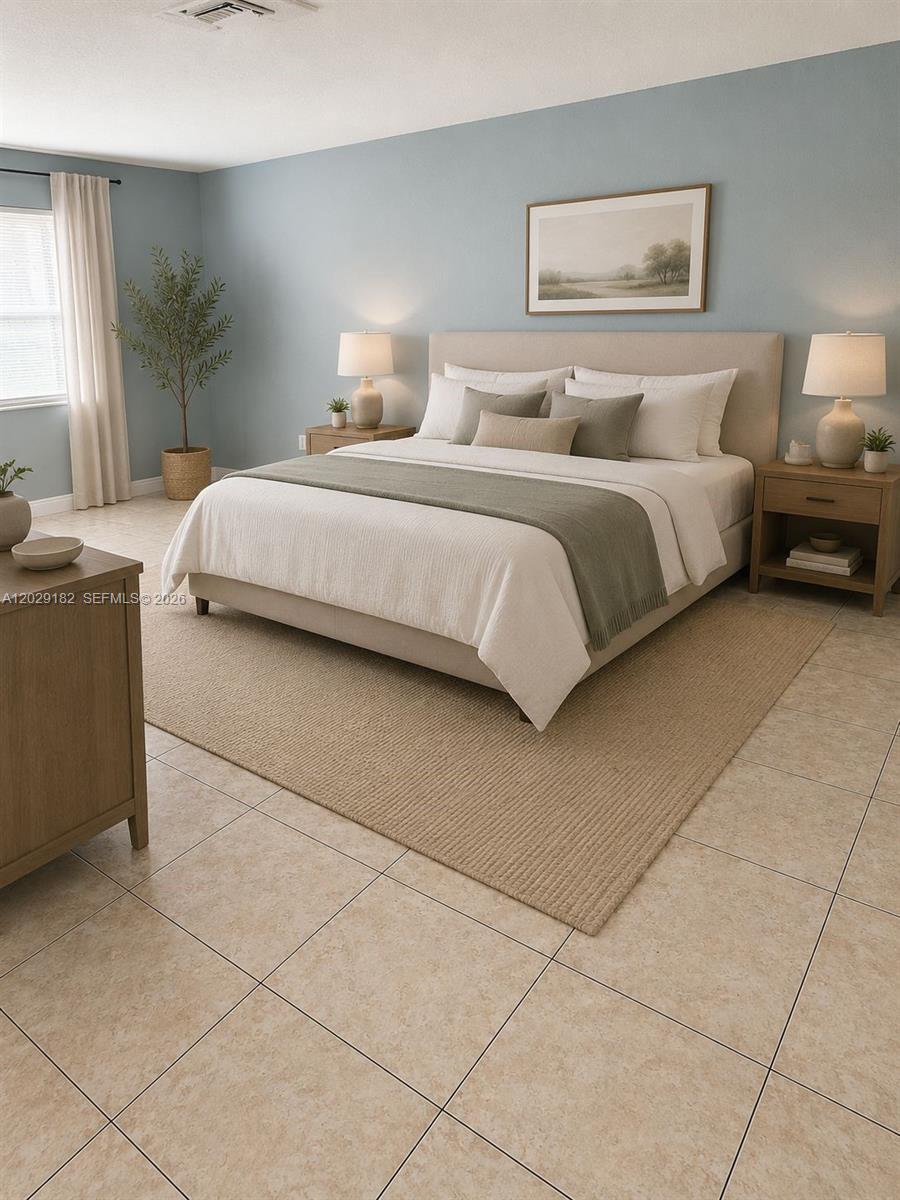 This is a bedroom featuring a bed with neutral bedding, nightstands, and light blue walls — 701 SW 1st St # 1, Dania Beach FL 33004, DANIA BEACH, FL