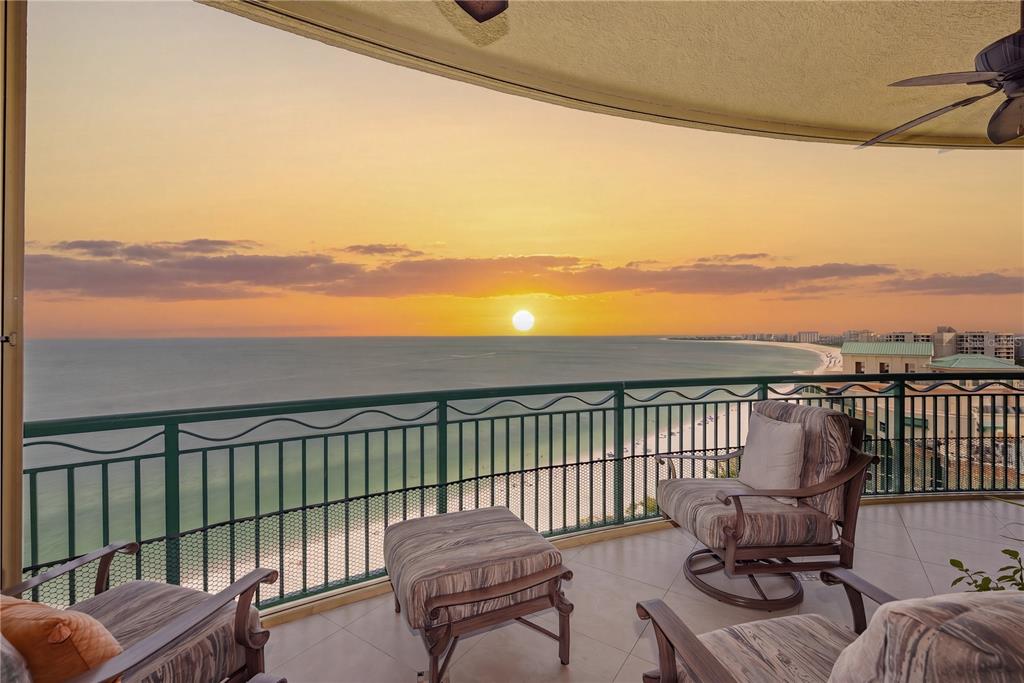 A balcony with patio furniture overlooks the ocean during a sunset — 940 CAPE MARCO DRIVE UNIT 1905, MARCO ISLAND, FL