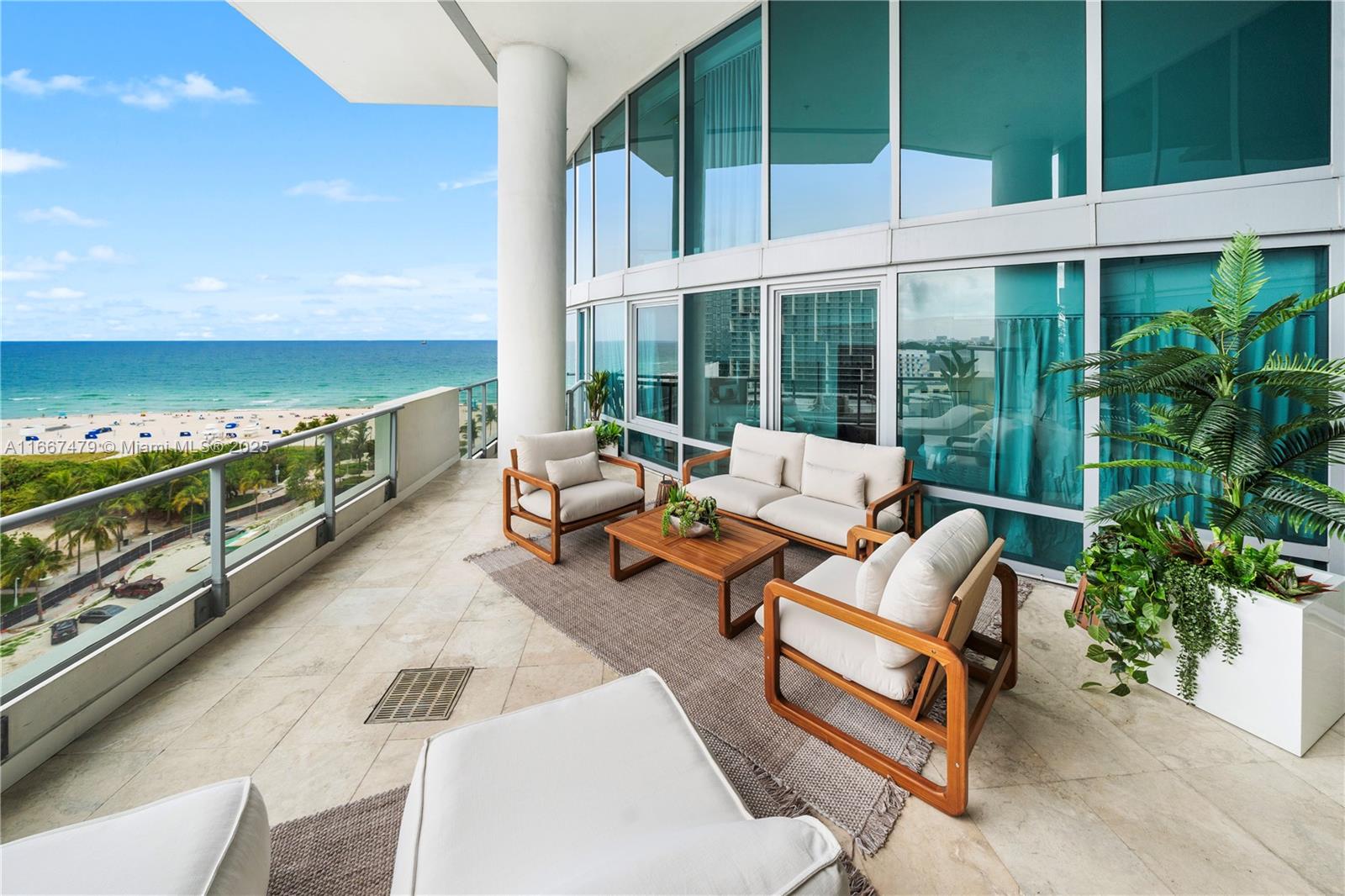 A spacious balcony features outdoor furniture, a rug, and panoramic views of the ocean — 101 20th St Th B # 1505, Miami Beach FL 33139, MIAMI BEACH, FL