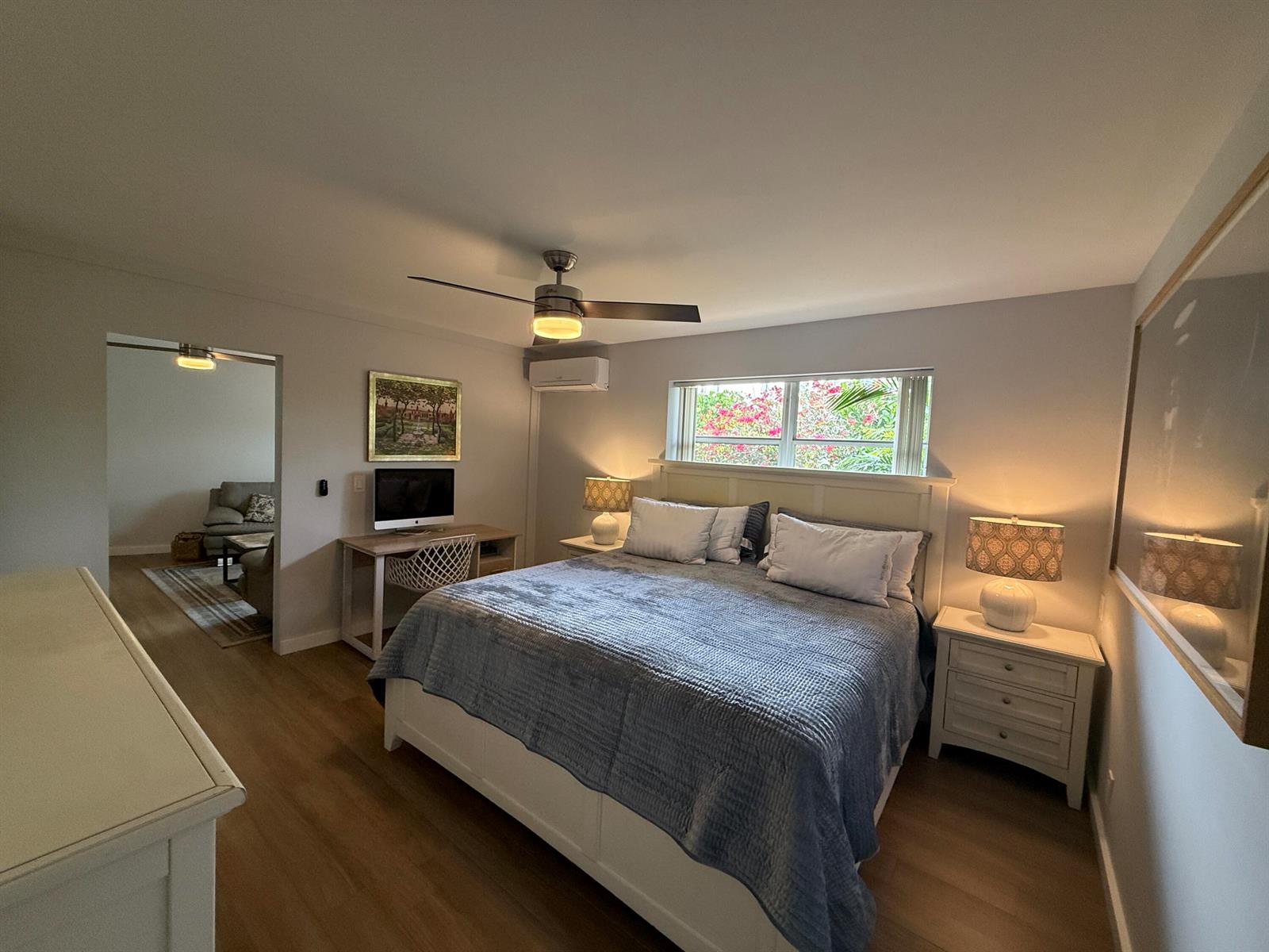 A bedroom features a king bed, a desk area, a ceiling fan, and light wood flooring — 203 Seacrest Lane # A, Delray Beach FL 33444, DELRAY BEACH, FL