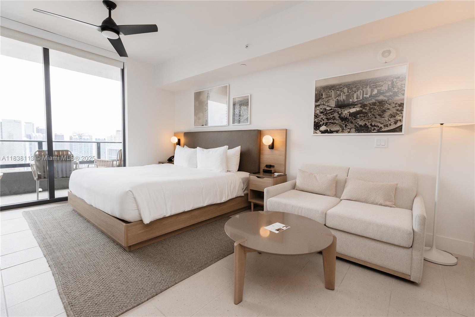 A modern bedroom features a bed, a sofa, a coffee table, and a balcony view — 601 NE 1st ave # 3612, Miami FL 33132, MIAMI, FL