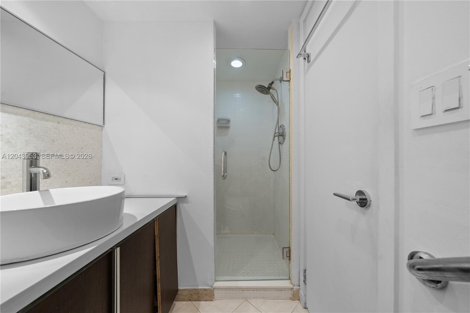 A bathroom features a vessel sink vanity, a glass-enclosed shower, and white walls — 11 Island Ave # 610, Miami Beach FL 33139, MIAMI BEACH, FL