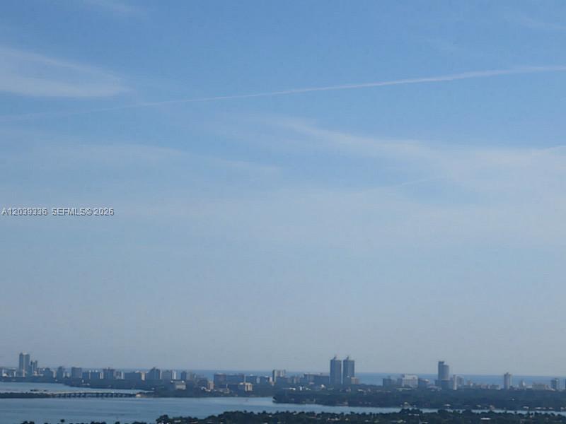 A high-angle view of a coastal city skyline across a body of water — 325 S BISCAYNE BLVD # 4122, Miami FL 33131, MIAMI, FL