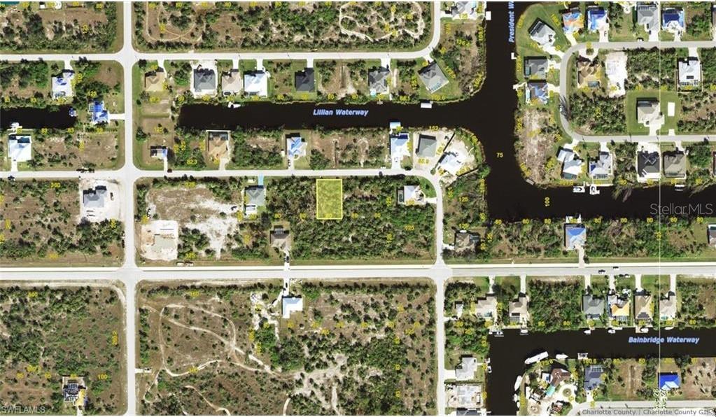 This is an aerial map showing a vacant residential lot highlighted in yellow — 14433 FORT MYERS AVENUE, PORT CHARLOTTE, FL