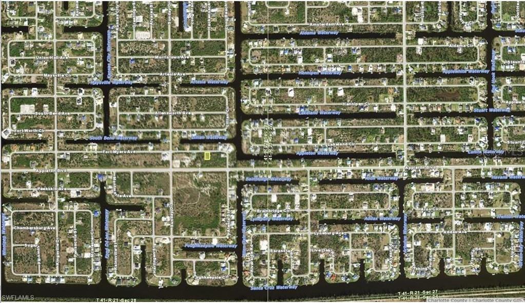This is an aerial map showing a residential neighborhood with canals and undeveloped lots — 14433 FORT MYERS AVENUE, PORT CHARLOTTE, FL