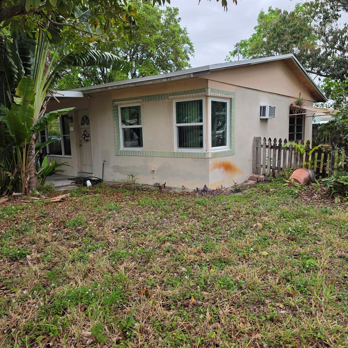 A single-story house with a beige stucco exterior, a bay window, and a front yard — 3170 NE 10th Terrace, Pompano Beach FL 33064, POMPANO BEACH, FL