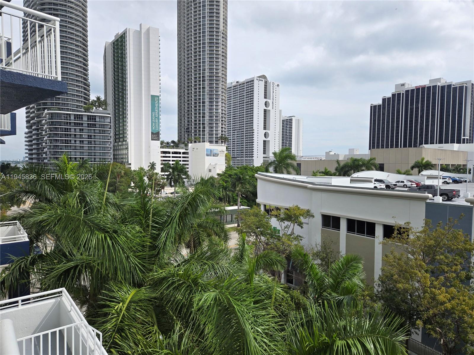 An elevated view of a city skyline featuring tall apartment buildings and palm trees — 275 NE 18th St # 503, Miami FL 33132, MIAMI, FL