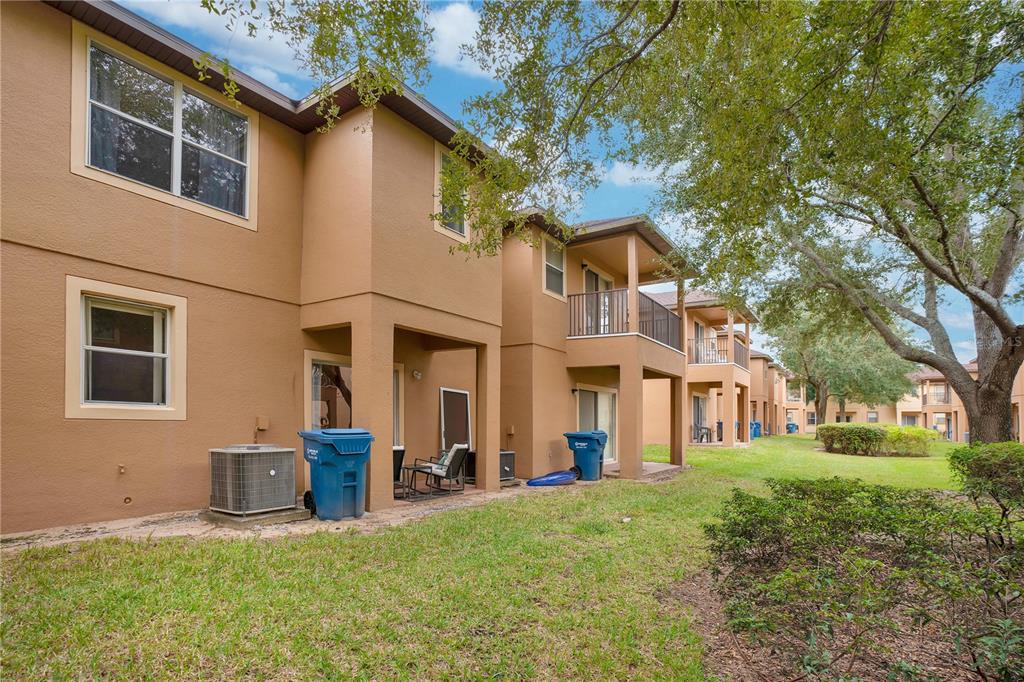 A swimming pool with a water slide and palm trees on a sunny day — 219 MIRAMAR AVENUE, DAVENPORT, FL