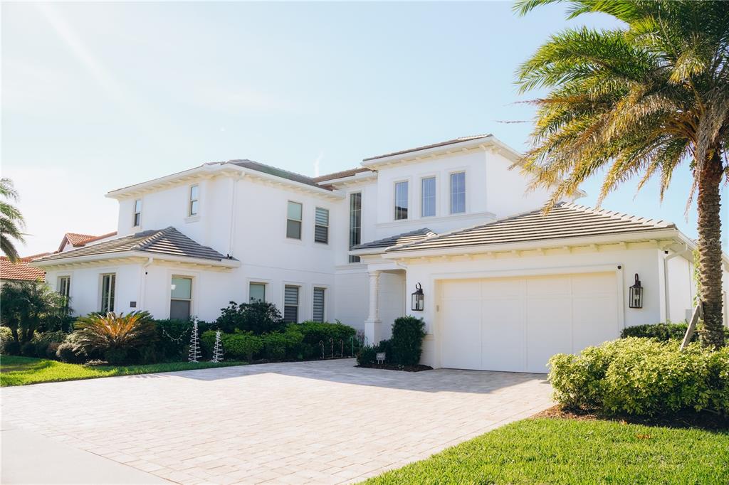A two-story white stucco house with a paved driveway and a two-car garage — 15505 SHOREBIRD LANE, WINTER GARDEN, FL