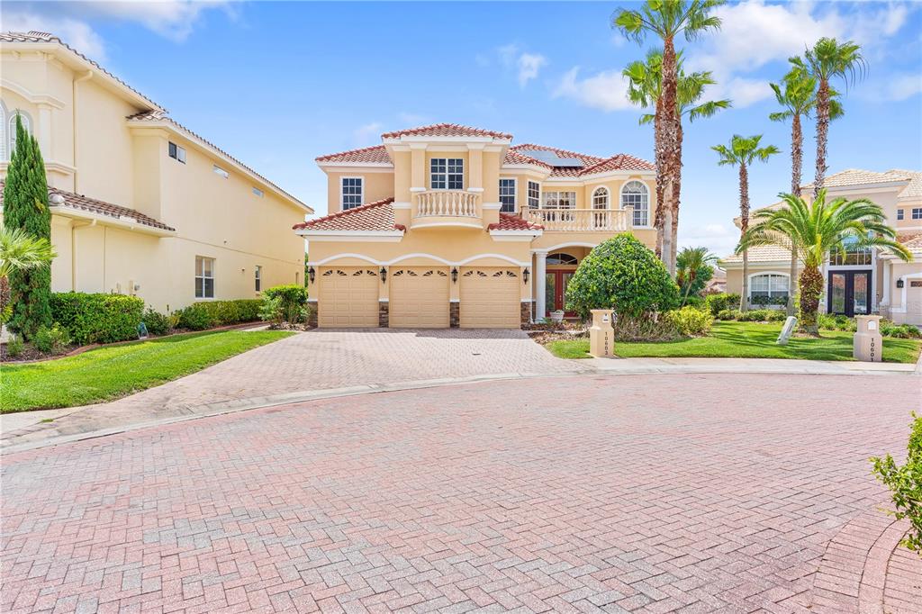 A two-story house with a three-car garage and a paved driveway in a suburban neighborhood — 10603 CAYMAN ISLE COURT, TAMPA, FL