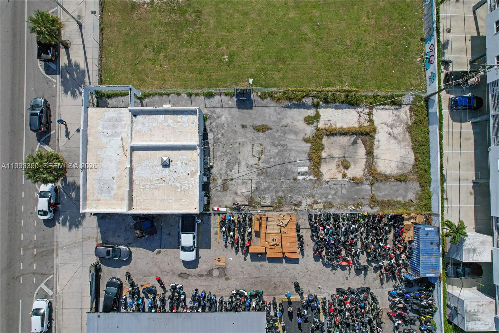 An aerial view shows a commercial building with a large paved lot filled with motorcycles — 727 W Flagler St, Miami FL 33130, MIAMI, FL