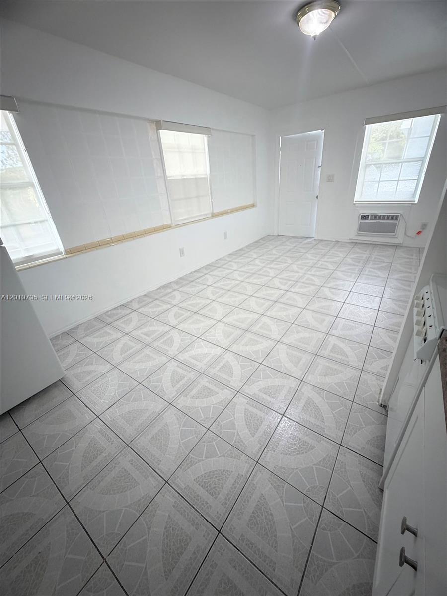A kitchen with white cabinets, tiled floors, and windows on two walls — 2736 SW 22nd STREET # 2, Miami FL 33133, MIAMI, FL