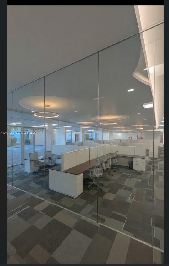 An office space features rows of cubicles with white partitions and gray patterned carpet flooring — 1501 Biscayne Blvd, Miami FL 33132, MIAMI, FL