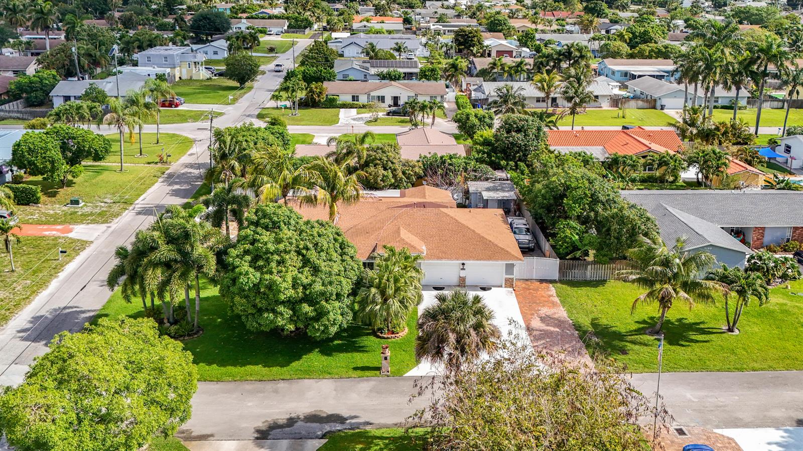 An aerial view shows a single-story house with a brown roof and a paved driveway — 3119 Indian Trail, Lake Worth FL 33462, LAKE WORTH, FL
