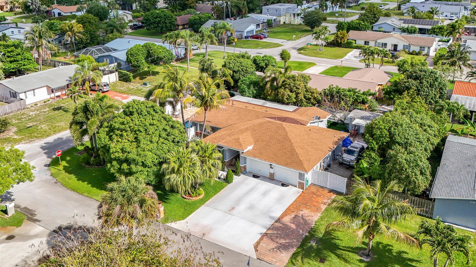 An aerial view of a single-story house with a brown roof and a concrete driveway — 3119 Indian Trail, Lake Worth FL 33462, LAKE WORTH, FL
