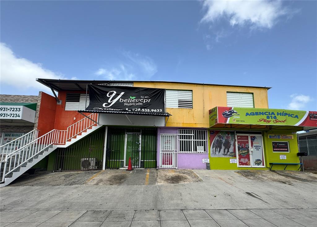 A two-story commercial building features a nutrition shop and a horse racing betting agency — A13 GALICIA AVE.,, CAROLINA, PR