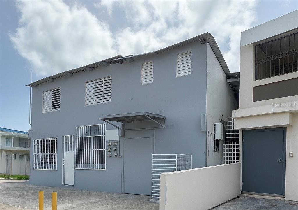 A two-story gray building with a metal roof and security bars on the windows — A13 GALICIA AVE.,, CAROLINA, PR