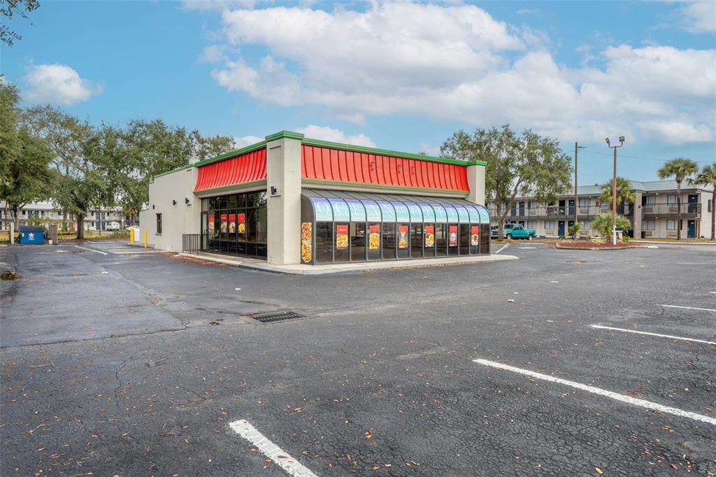 A commercial building with a red metal roof and a glass-enclosed dining area — 6620 E DR MARTIN LUTHER KING JR BOULEVARD, TAMPA, FL