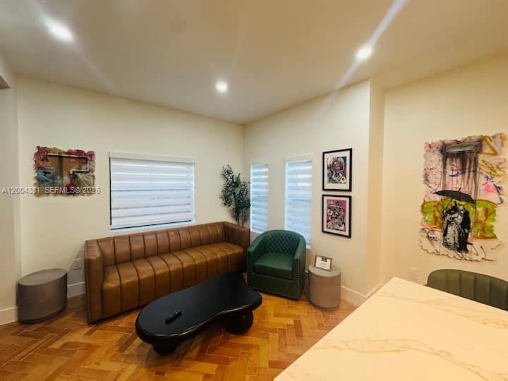A living room features a brown leather sofa, a green armchair, and a coffee table — 905 SW 13th Ct # 905, Miami FL 33135, MIAMI, FL