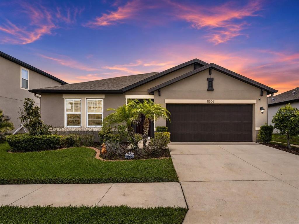 A single-story suburban house with a brown garage and a palm tree in the front — 11906 BAHIA VALLEY DRIVE, RIVERVIEW, FL