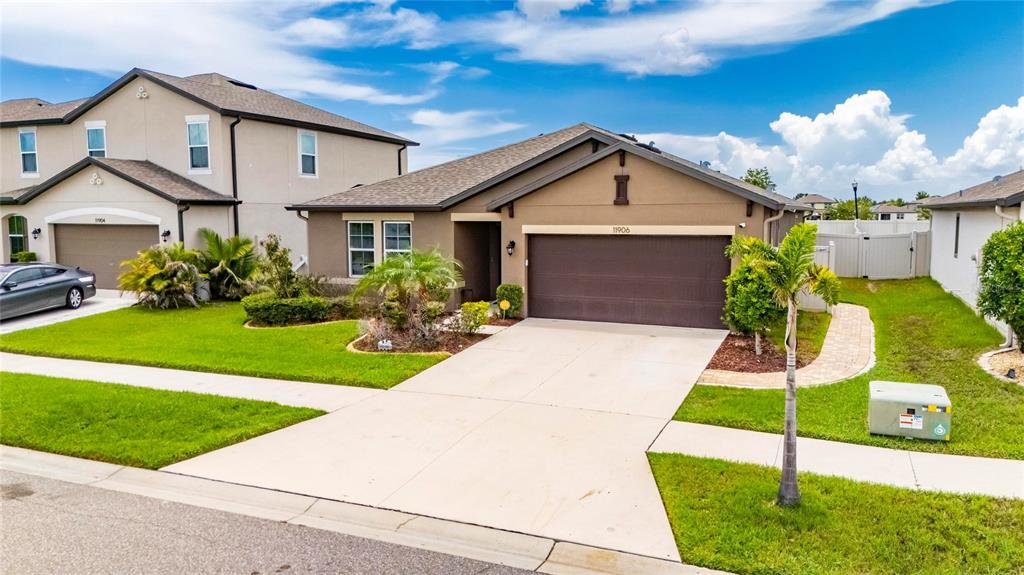 A single-story suburban house with a brown garage and a concrete driveway — 11906 BAHIA VALLEY DRIVE, RIVERVIEW, FL