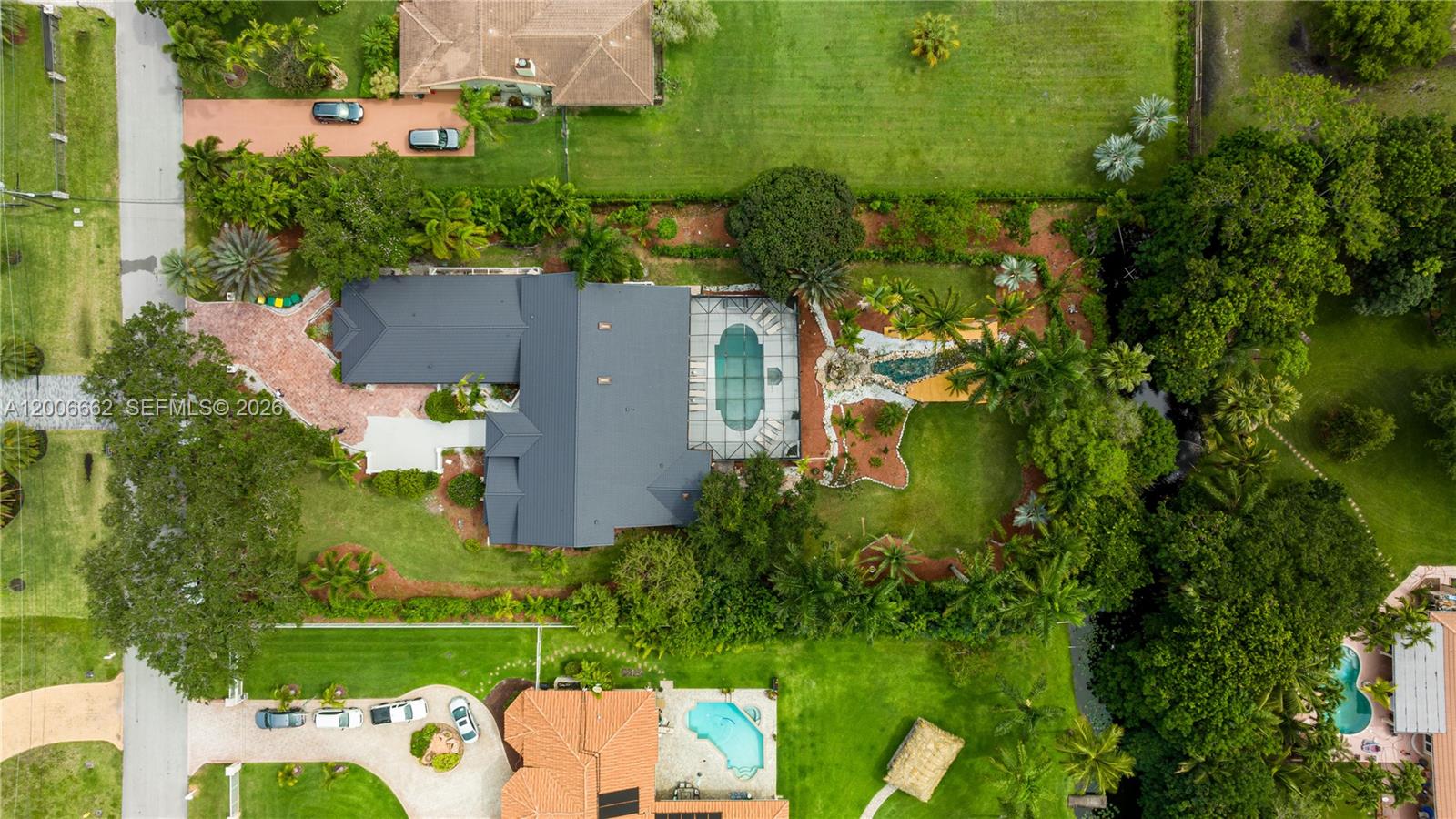 An aerial view shows two residential properties with swimming pools, lush landscaping, and paved driveways — 1361 NW 116th Ave, Plantation FL 33323, PLANTATION, FL
