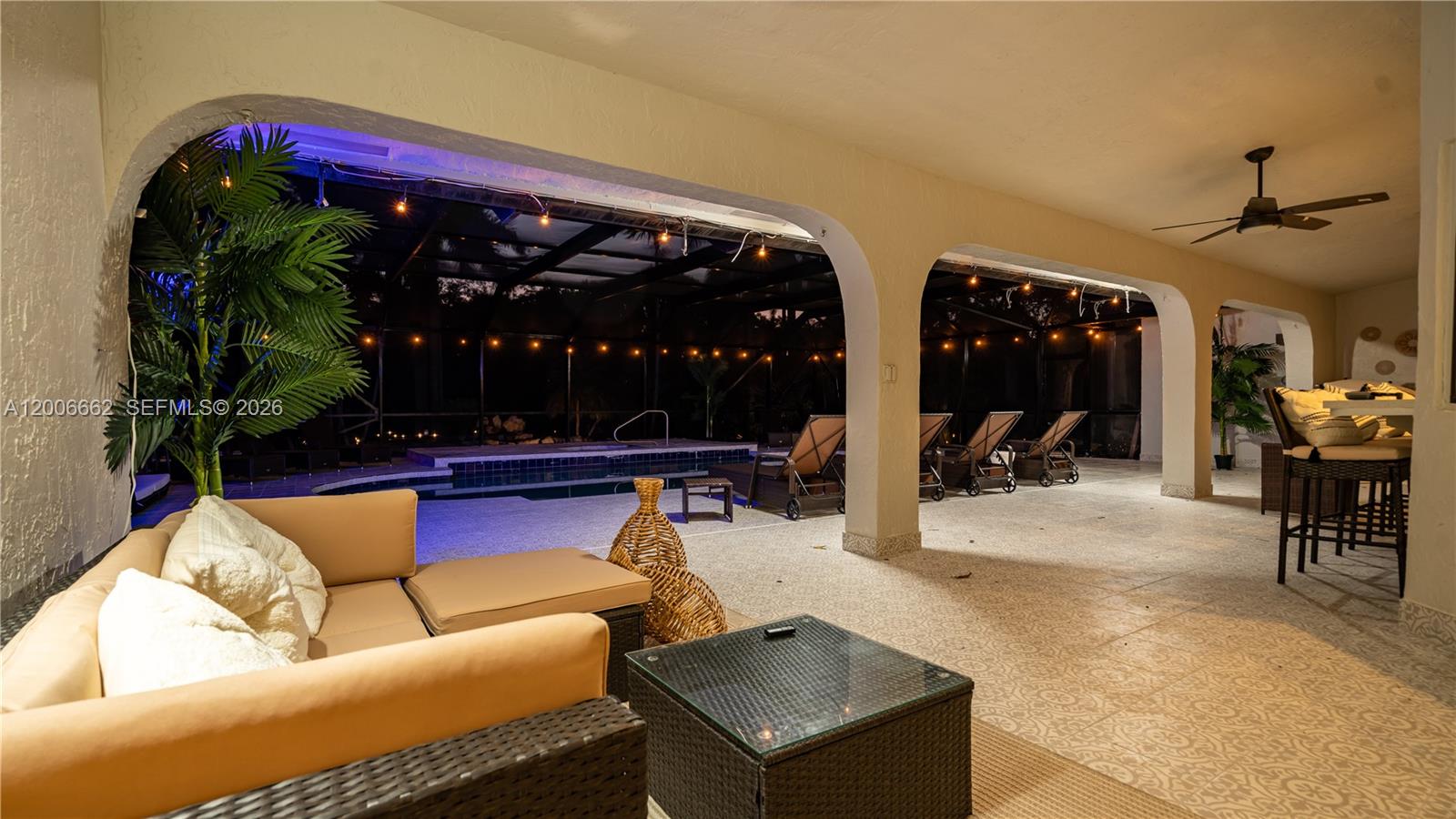 A covered patio features outdoor furniture, a swimming pool, and string lights at night — 1361 NW 116th Ave, Plantation FL 33323, PLANTATION, FL