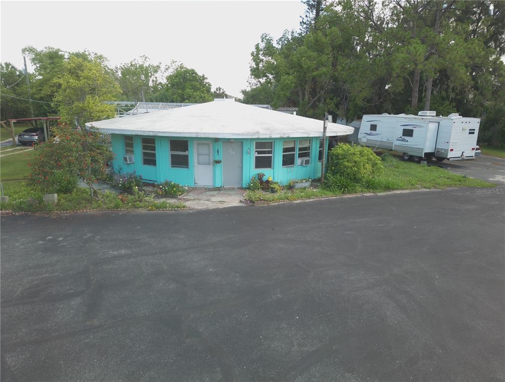 A round, turquoise house with a white roof sits next to a parked travel trailer — 1603, 1605,1608,1611 W SHELL POINT ROAD, RUSKIN, FL