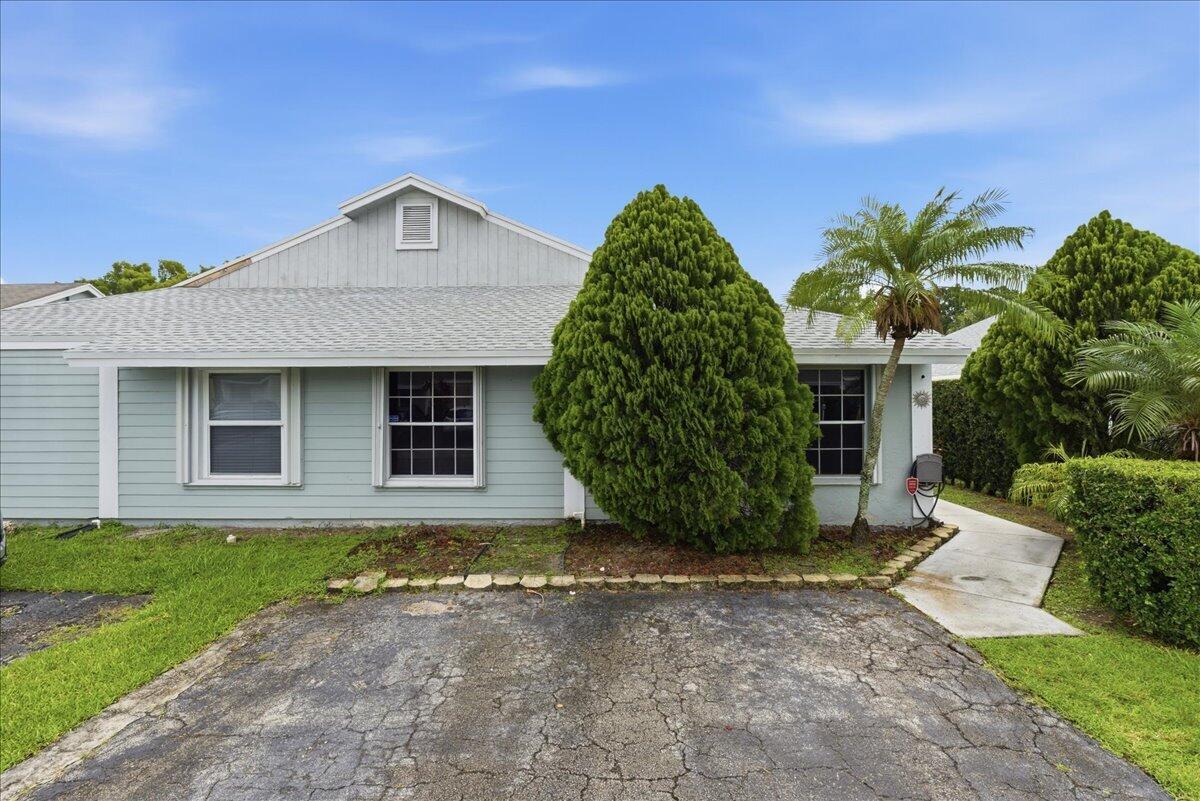 A light blue single-story house with a cracked asphalt driveway and a large evergreen tree — 970 SW 111th Way, Davie FL 33324, DAVIE, FL