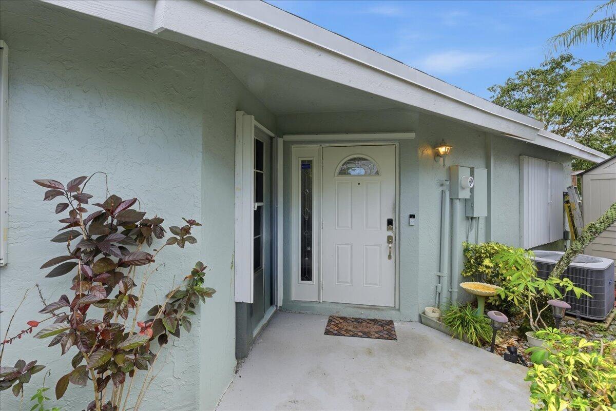 A light green house exterior features a white front door with a side window panel — 970 SW 111th Way, Davie FL 33324, DAVIE, FL
