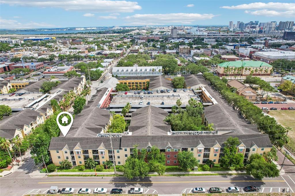 An aerial view shows a multi-story apartment complex with a central parking garage — 1810 E PALM AVENUE UNIT 5322, TAMPA, FL