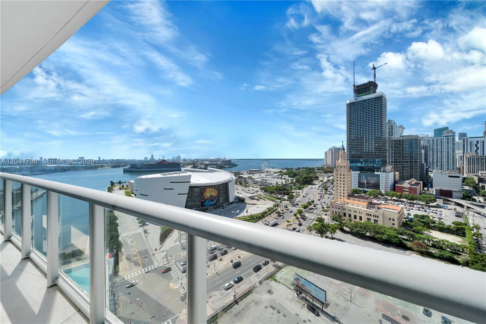 A high-rise balcony overlooks the Kaseya Center, the Miami waterfront, and the downtown city skyline — 888 Biscayne Blvd # 2101, Miami FL 33132, MIAMI, FL
