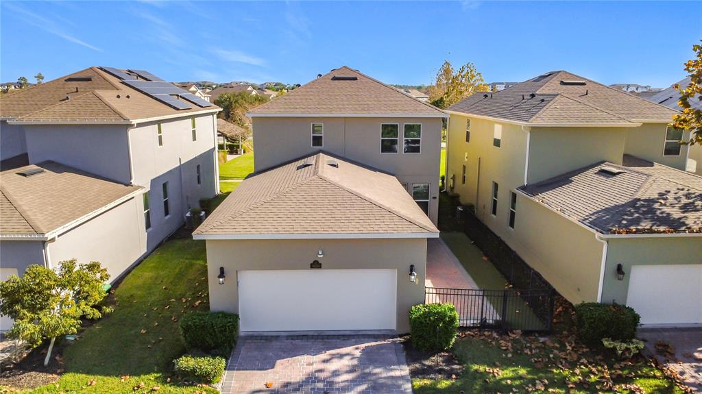 An aerial view shows the exterior of a two-story house with a two-car garage — 16330 BRISK BREEZE ALLEY, WINTER GARDEN, FL