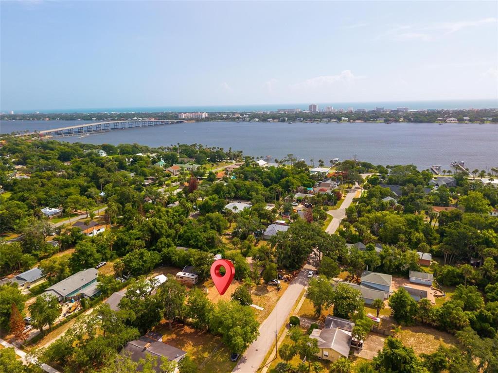 An aerial view shows a residential property marked with a pin near a large body of water — 71 FAIRVIEW AVENUE, ORMOND BEACH, FL