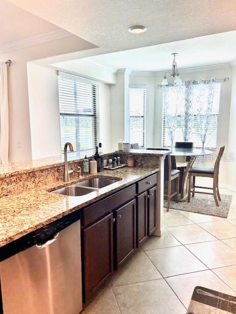 A kitchen with granite countertops, dark wood cabinets, and a stainless steel dishwasher — 16804 VARDON TERRACE UNIT 102, BRADENTON, FL