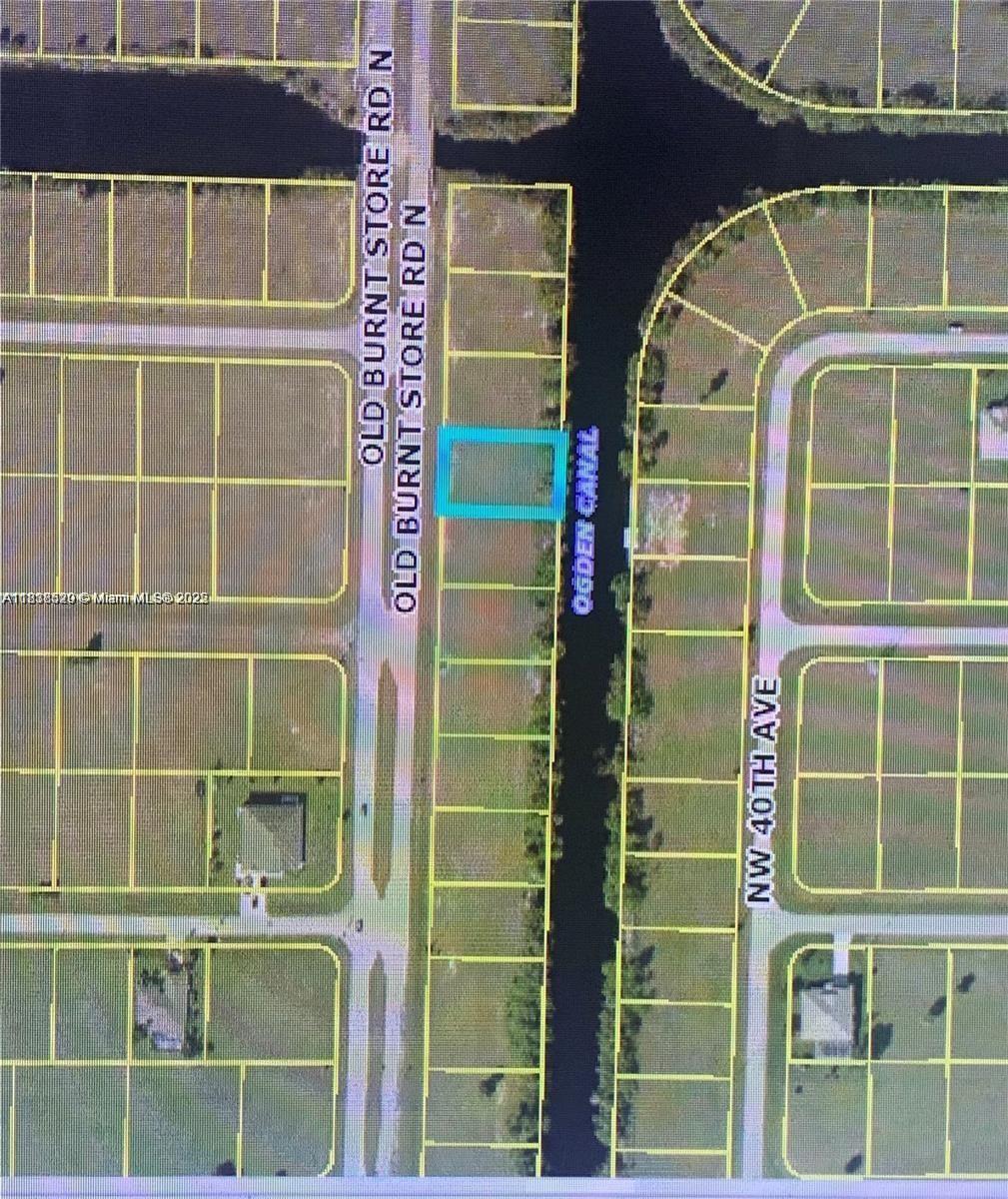 This is an aerial map showing a highlighted vacant lot situated between a road and a canal — 3839 Old Burnt Rd, Cape Coral FL 33993, CAPE CORAL, FL