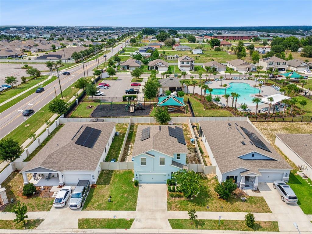 A two-story light blue house features a two-car garage and a concrete driveway — 310 CITRUS POINTE DRIVE, DAVENPORT, FL