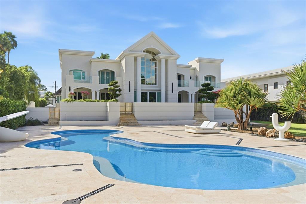A large white house with a swimming pool and patio in the backyard — 85 ORQUIDIA, SAN JUAN, PR