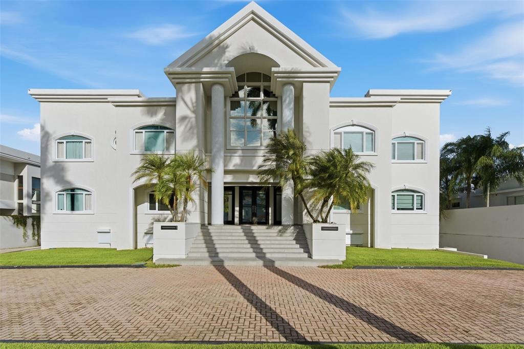 A large, white, two-story modern house with a central columned entrance and a brick driveway — 85 ORQUIDIA, SAN JUAN, PR