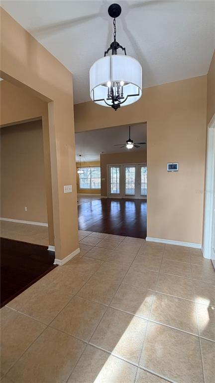 A tiled entryway leads to a living area with dark wood floors and glass doors — 2782 HIGH RIDGE DRIVE, LAKELAND, FL