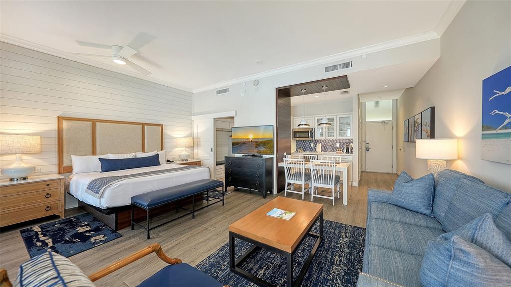 A hotel room features a king bed, a sitting area, and a small kitchenette — 225 SANDS POINT ROAD UNIT 6201, LONGBOAT KEY, FL