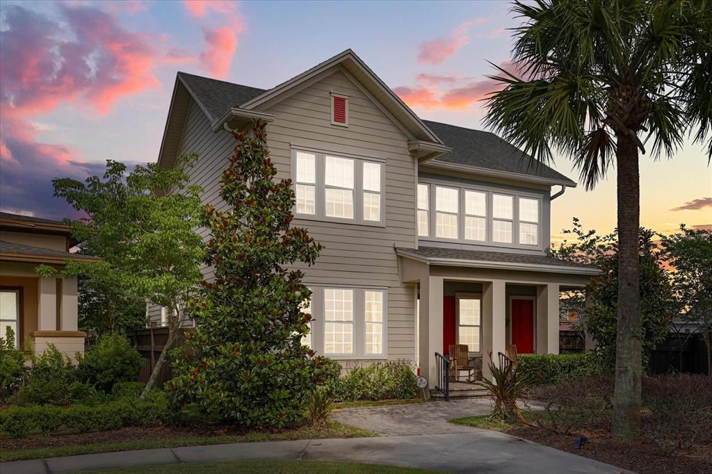 A two-story house with light siding, a front porch, and a palm tree at sunset — 13358 BEEBE ALLEY, ORLANDO, FL
