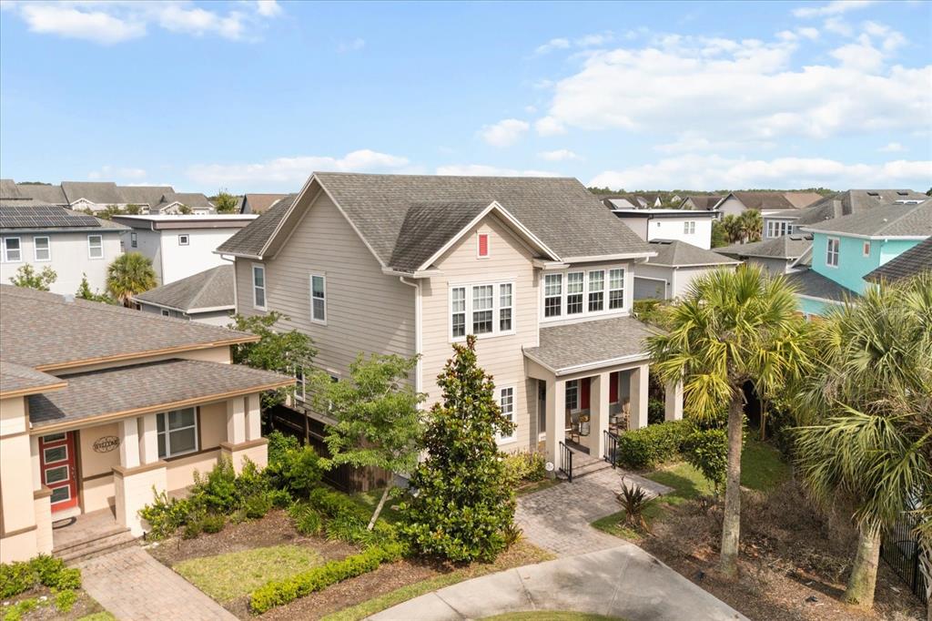 An aerial view shows a two-story tan house with a shingled roof and porch — 13358 BEEBE ALLEY, ORLANDO, FL