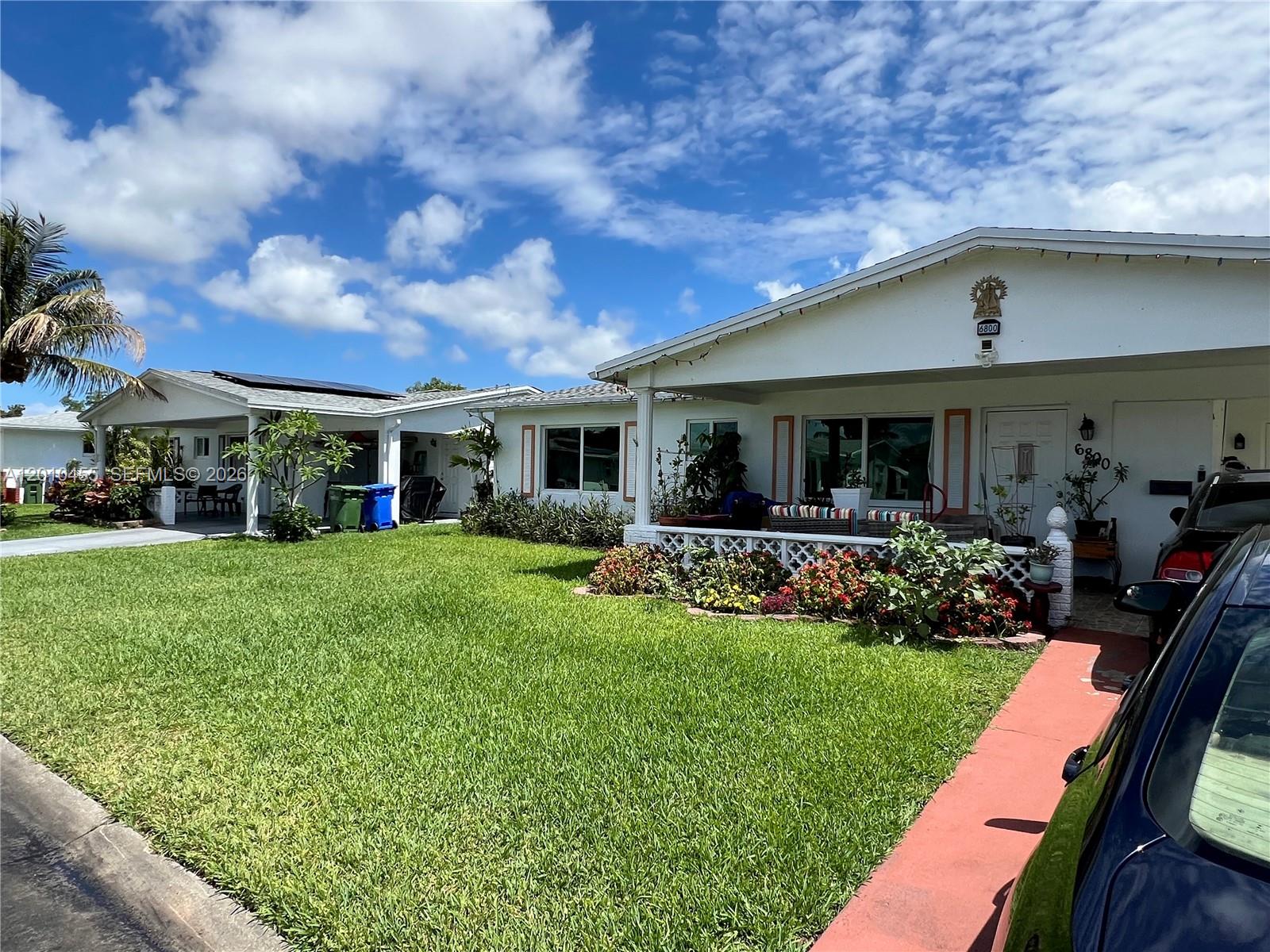 A single-story house with a white exterior, a covered porch, and a green front lawn — 6800 NW 15th St, Margate FL 33063, MARGATE, FL
